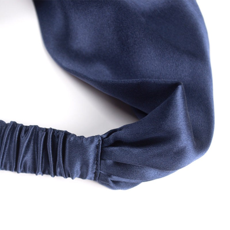 Close up of Twist Mulberry Silk Headband in Navy Blue, crafted with 19 momme pure mulberry silk.