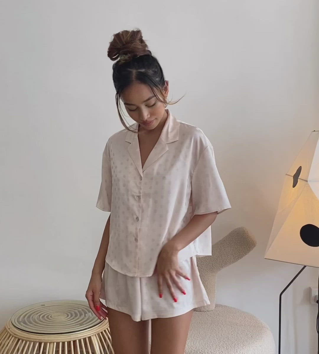 Video of the Julia Silk Pyjama Set in Blush. Front and back detailing polkadot pyjamas. Made from 100% soft and smooth viscose. Shop yours now at White Trousseau Singapore. 